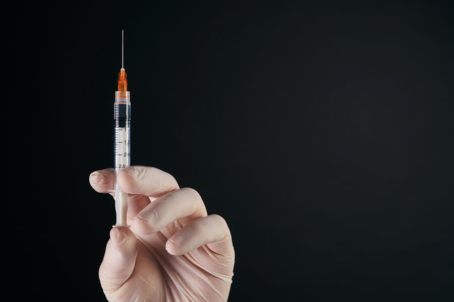 holding a syringe